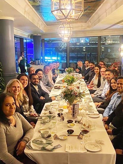 Dentists sat at a long table during a Dine with Denplan event