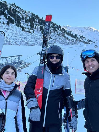 Three Denplan dentists standing with the ski gear at the bottom of a ski slope