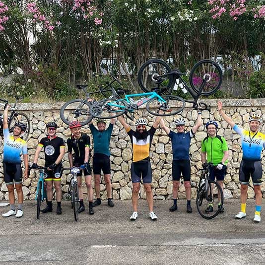 Denplan dentists celebrating with their bikes held in the air