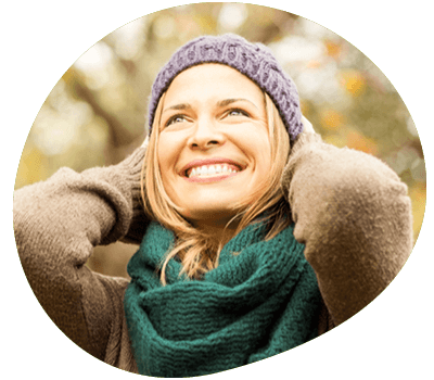 Woman smiling wearing wooly hat and scarf