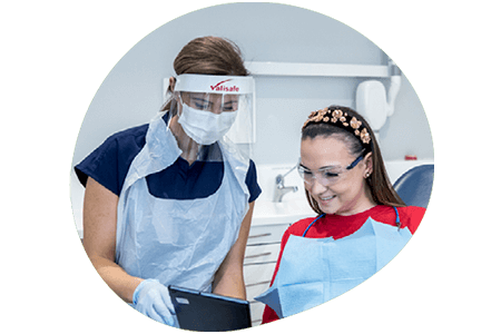 Dentist and patient looking at a tablet