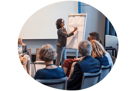 Woman at flip chart hosting a training session