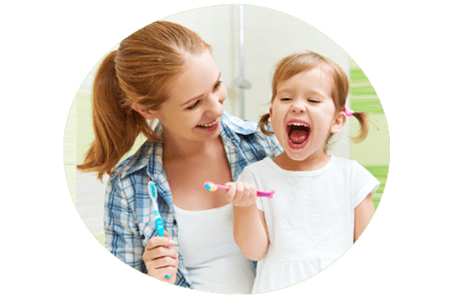 Toddler and mum learning to brush their teeth