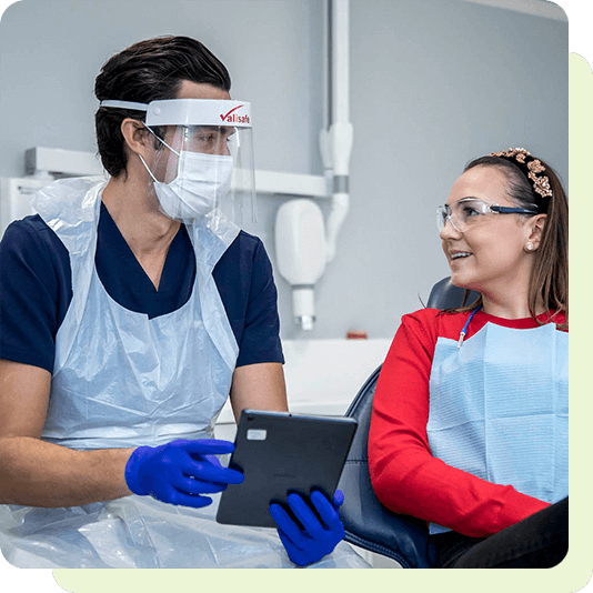 Dentist in treatment room with patient