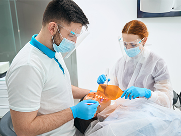 Dentist and dental nurse during appointment with patient