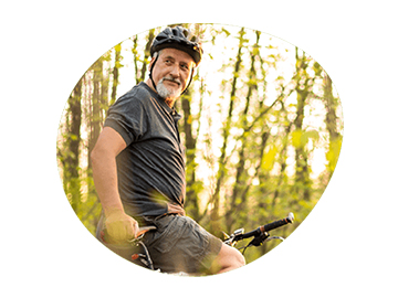 Man smiling on mountain bike in the forest