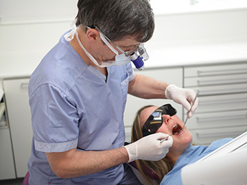 Dentsit working on a patient