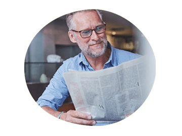 Man in a coffee shop reading the latest dental news