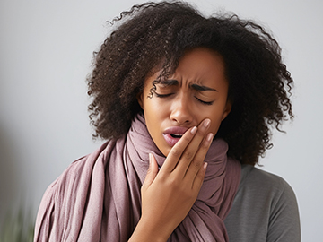 Woman holding her face with tooth pain