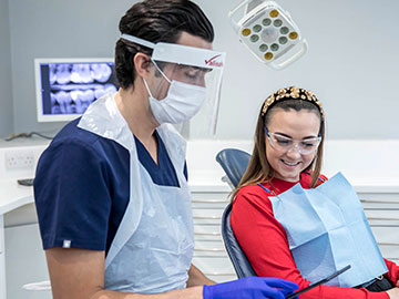 Dentist and patient looking at an iPad